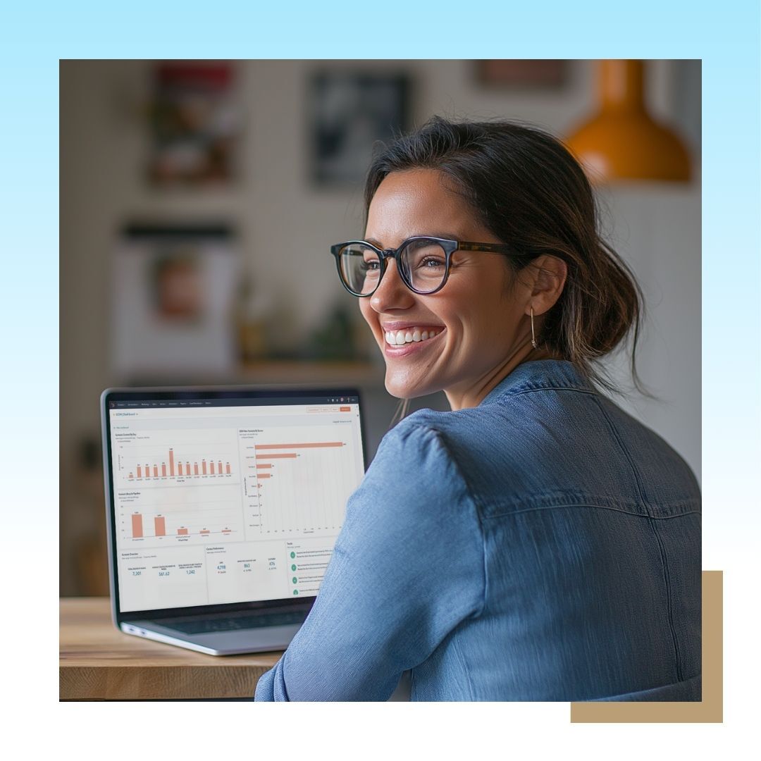 Image of a smiling female professional working on her laptop